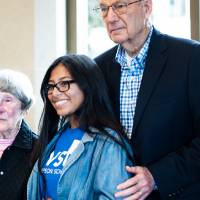 A Thompson Scholar standing with Robert and Ellen Thompson.